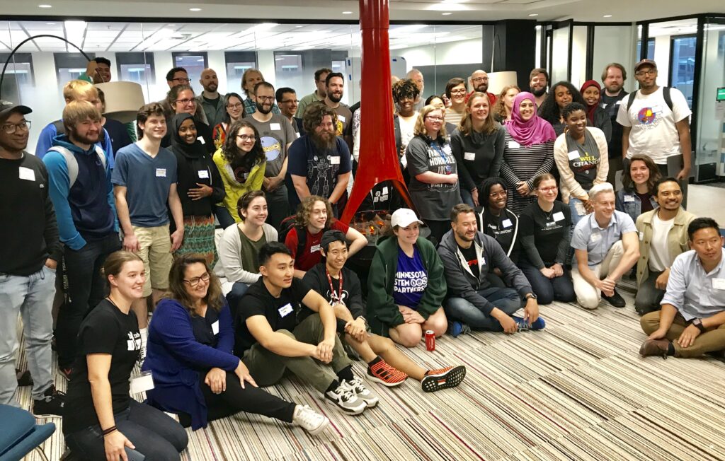 Large group of people posing for a photo at Code Switch hackathon.