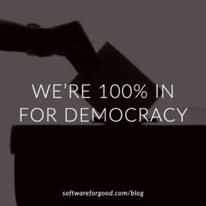 Image of a hand putting a ballot into a box with text "We're 100% In for Democracy." softwareforgood.com/blog