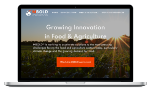 Image of computer showing MBOLD website home page, with headline "Growing Innovation in Food and Agriculture."